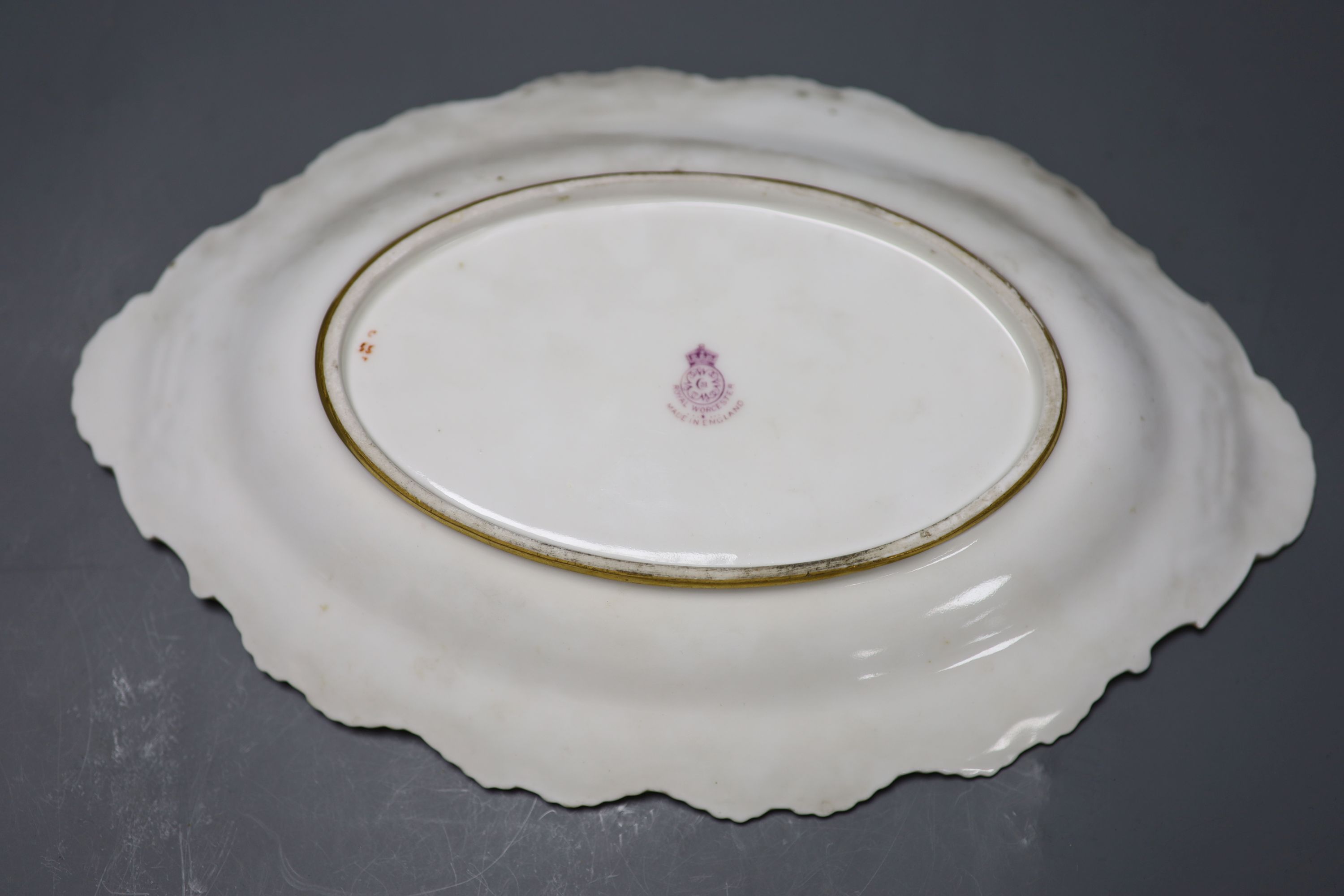 A Royal Worcester fruit painted dessert dish, signed Lockyer, length 31cm